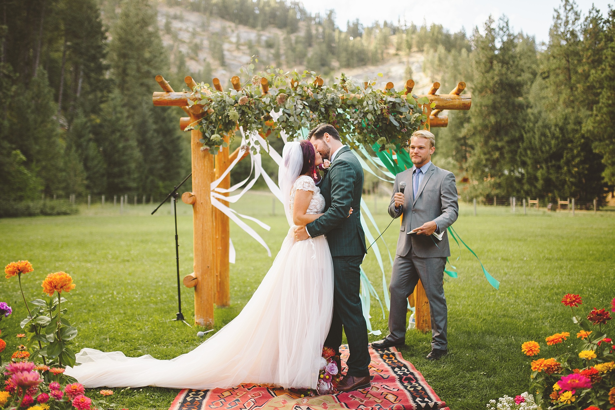first kiss at wedding in woods of washington