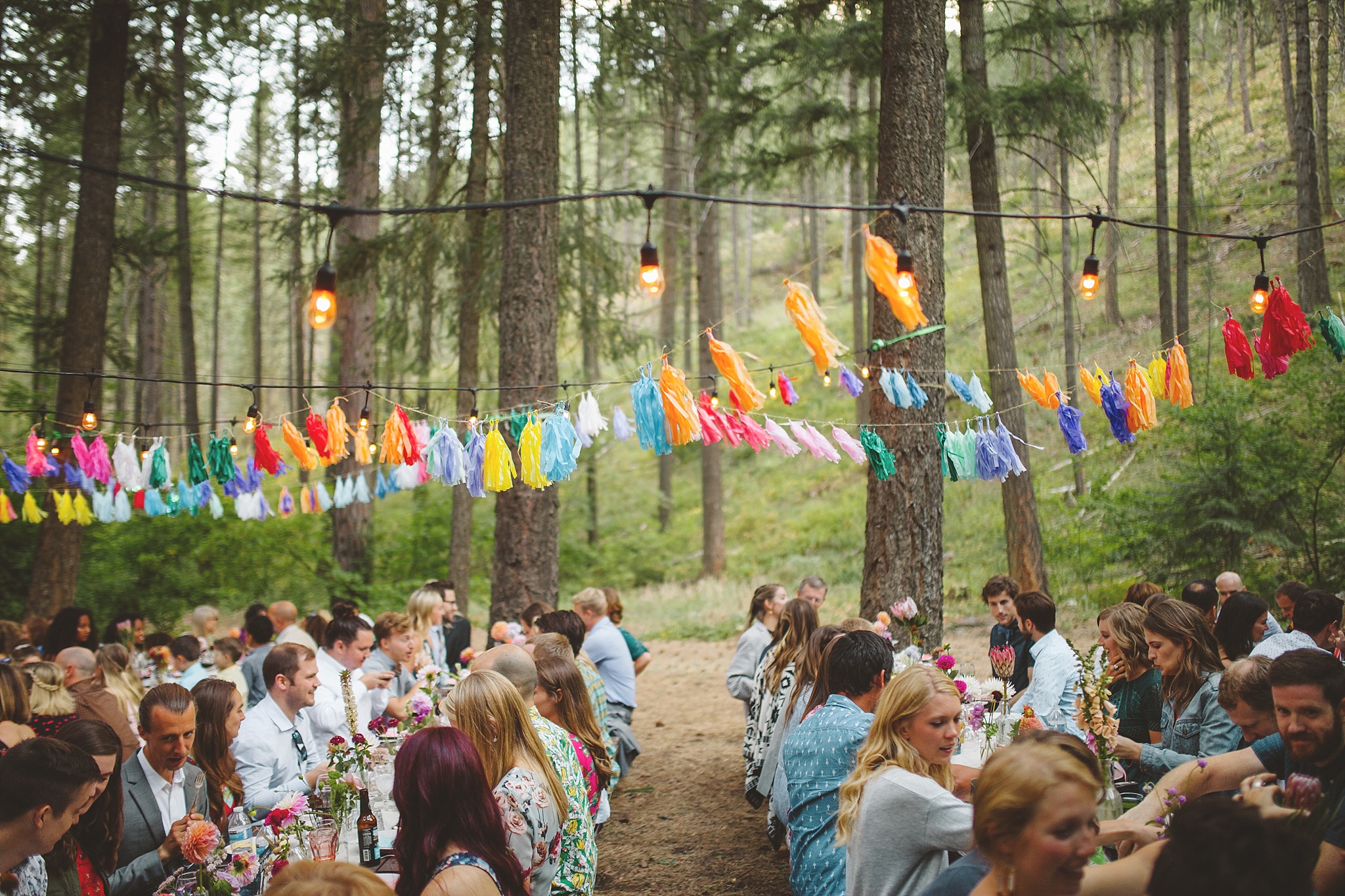 colorful outdoor wedding reception in woods